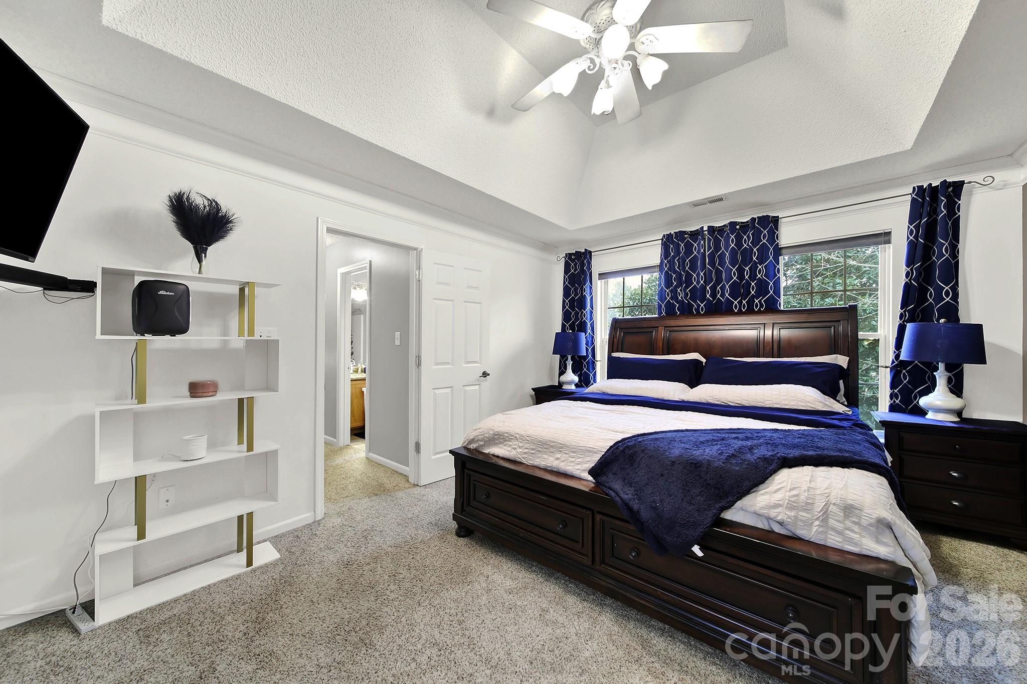 308 Patrick Avenue Southwest Concord, NC 28025 - Photo 15 of 26 a bedroom with a bed and a chandelier