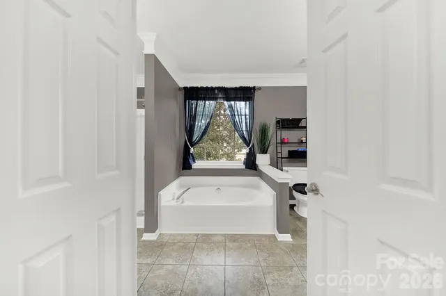 a bathroom with a bathtub and window