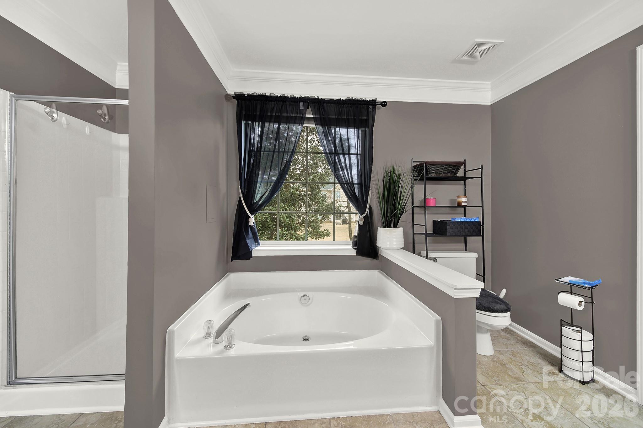 308 Patrick Avenue Southwest Concord, NC 28025 - Photo 17 of 26 a bathroom with a bathtub and a window