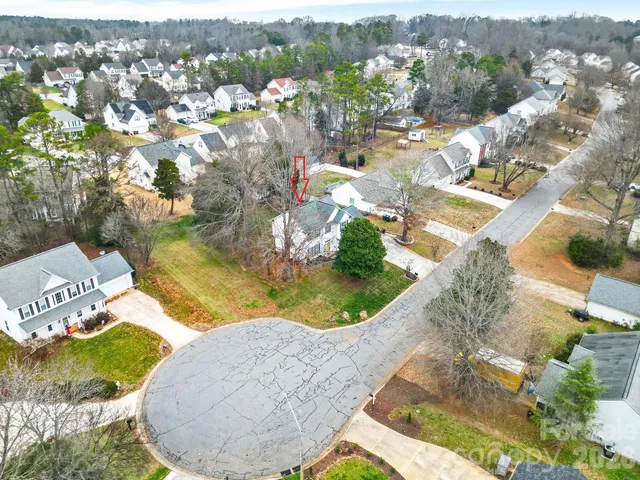 an aerial view of a house with a yard and lake view