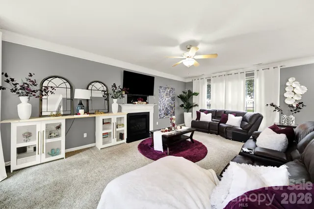 a living room with furniture a fireplace and a flat screen tv