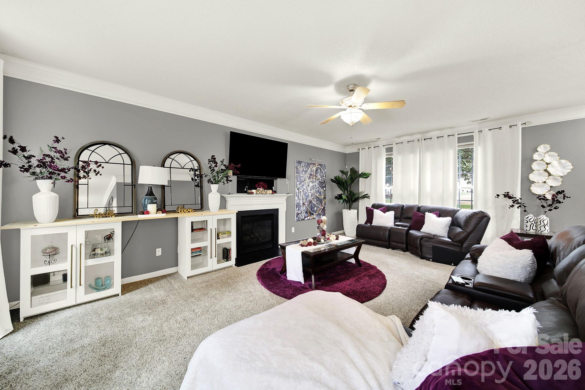 308 Patrick Avenue Southwest Concord, NC 28025 - Photo 4 of 26 a living room with furniture a fireplace and a flat screen tv