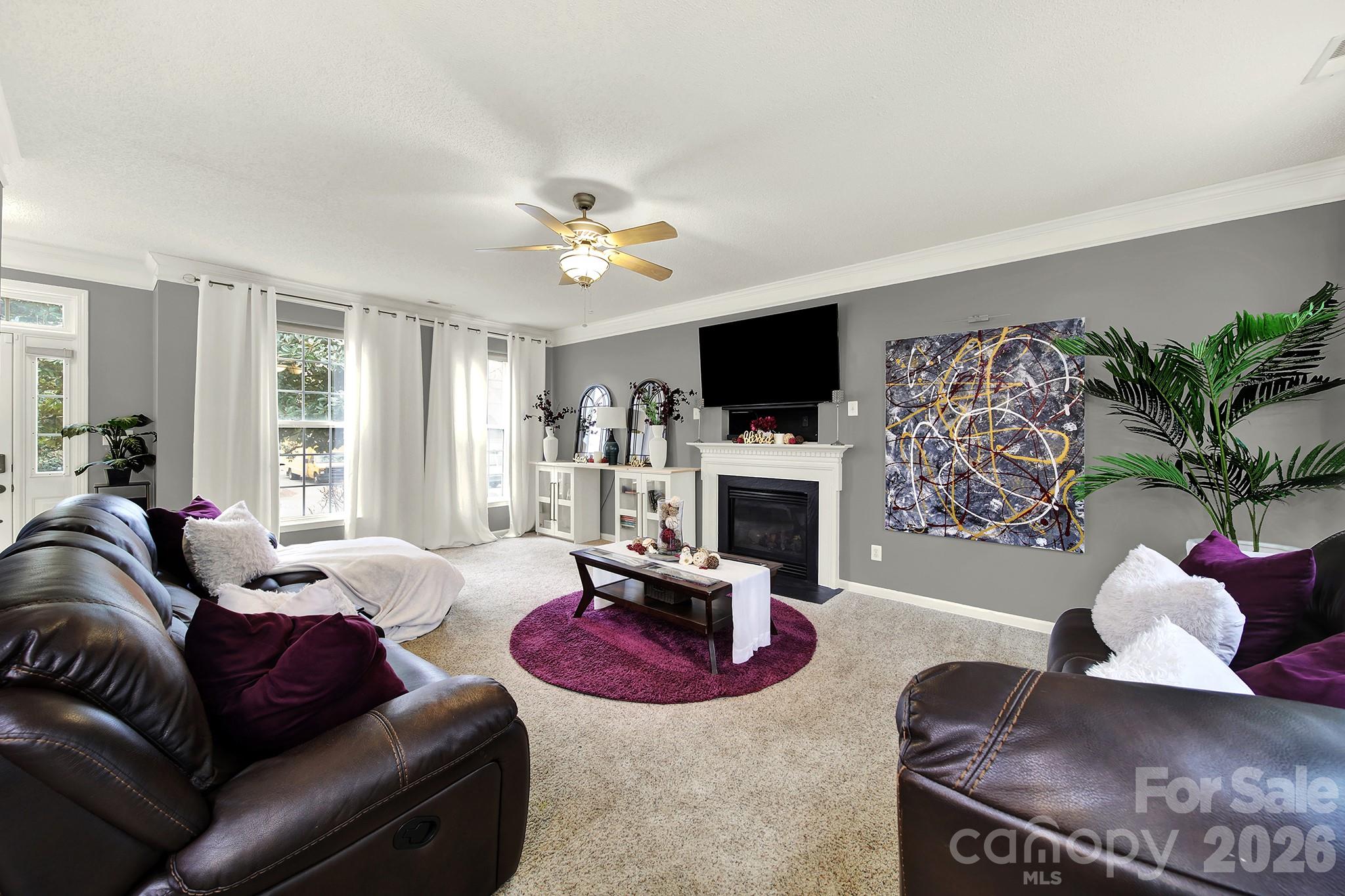 308 Patrick Avenue Southwest Concord, NC 28025 - Photo 5 of 26 a living room with furniture a flat screen tv and a fireplace
