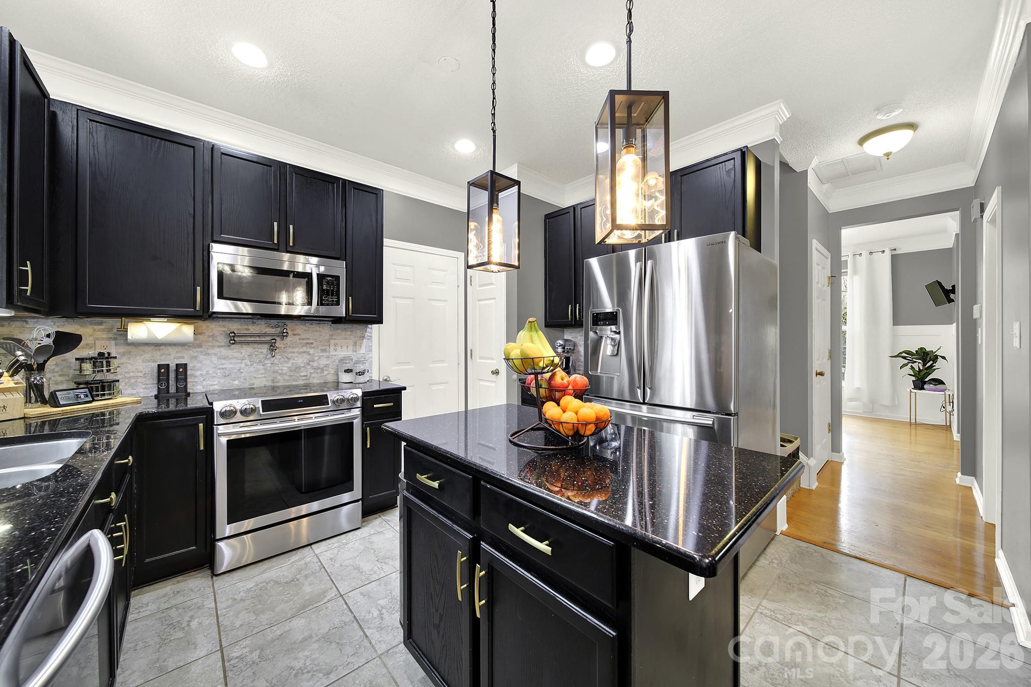 308 Patrick Avenue Southwest Concord, NC 28025 - Photo 7 of 26 a kitchen with kitchen island a counter space stainless steel appliances and cabinets