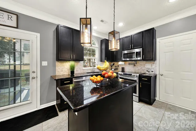 a kitchen with stainless steel appliances a sink stove and refrigerator