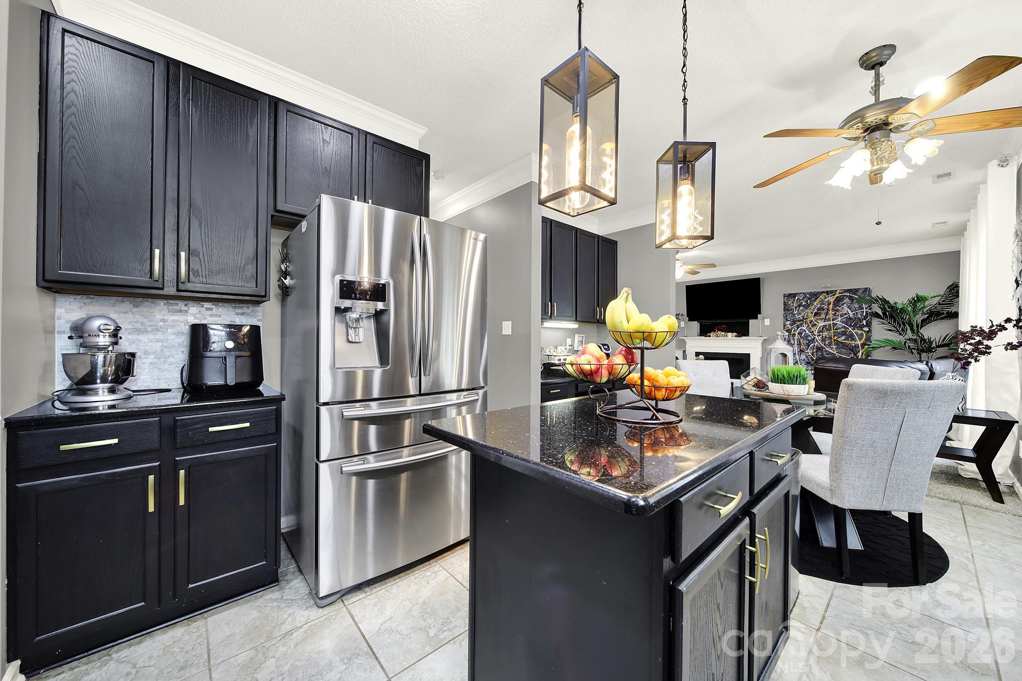 308 Patrick Avenue Southwest Concord, NC 28025 - Photo 9 of 26 a kitchen with stainless steel appliances granite countertop a refrigerator a stove a sink dishwasher and a refrigerator with wooden cabinets