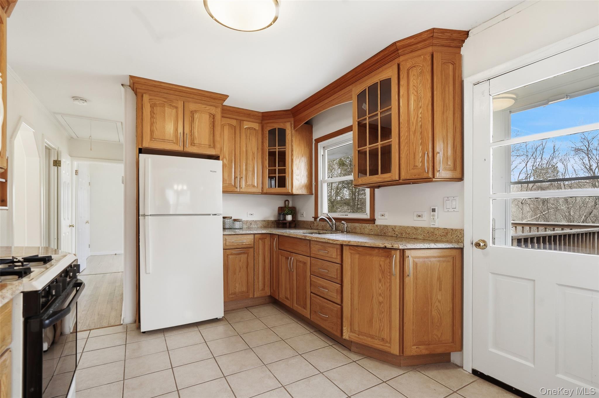 59 Brook Street Mahopac, NY 10541 - Photo 12 of 37 Sunfilled kitchen with door leading to expansive deck and yard.