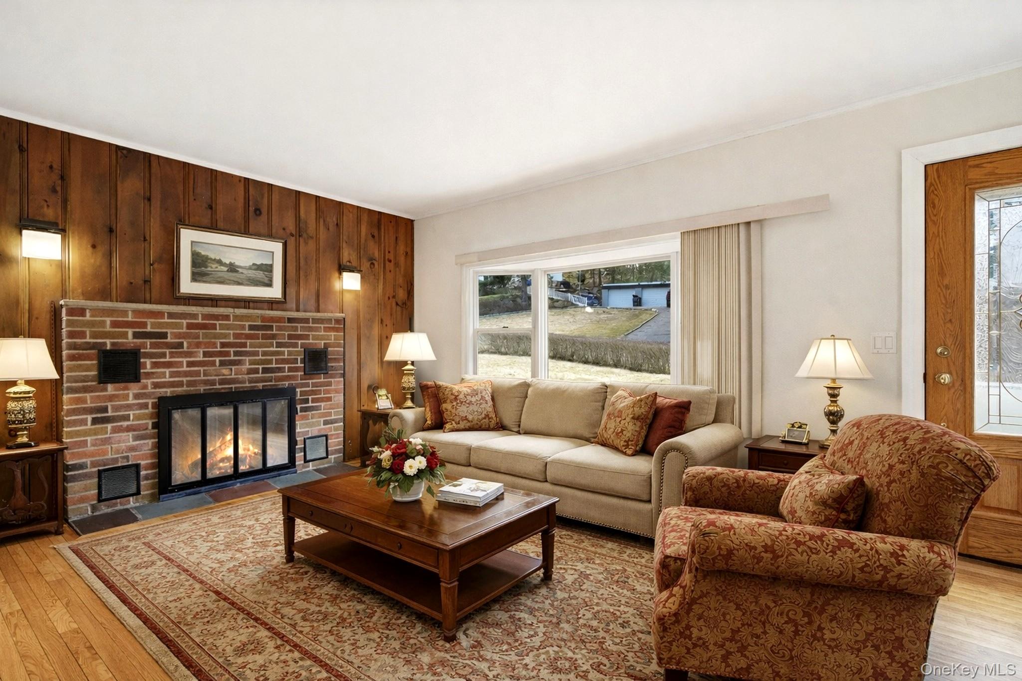 59 Brook Street Mahopac, NY 10541 - Photo 2 of 37 Living room with hardwood floors, fireplace and bay window. Virtually staged.