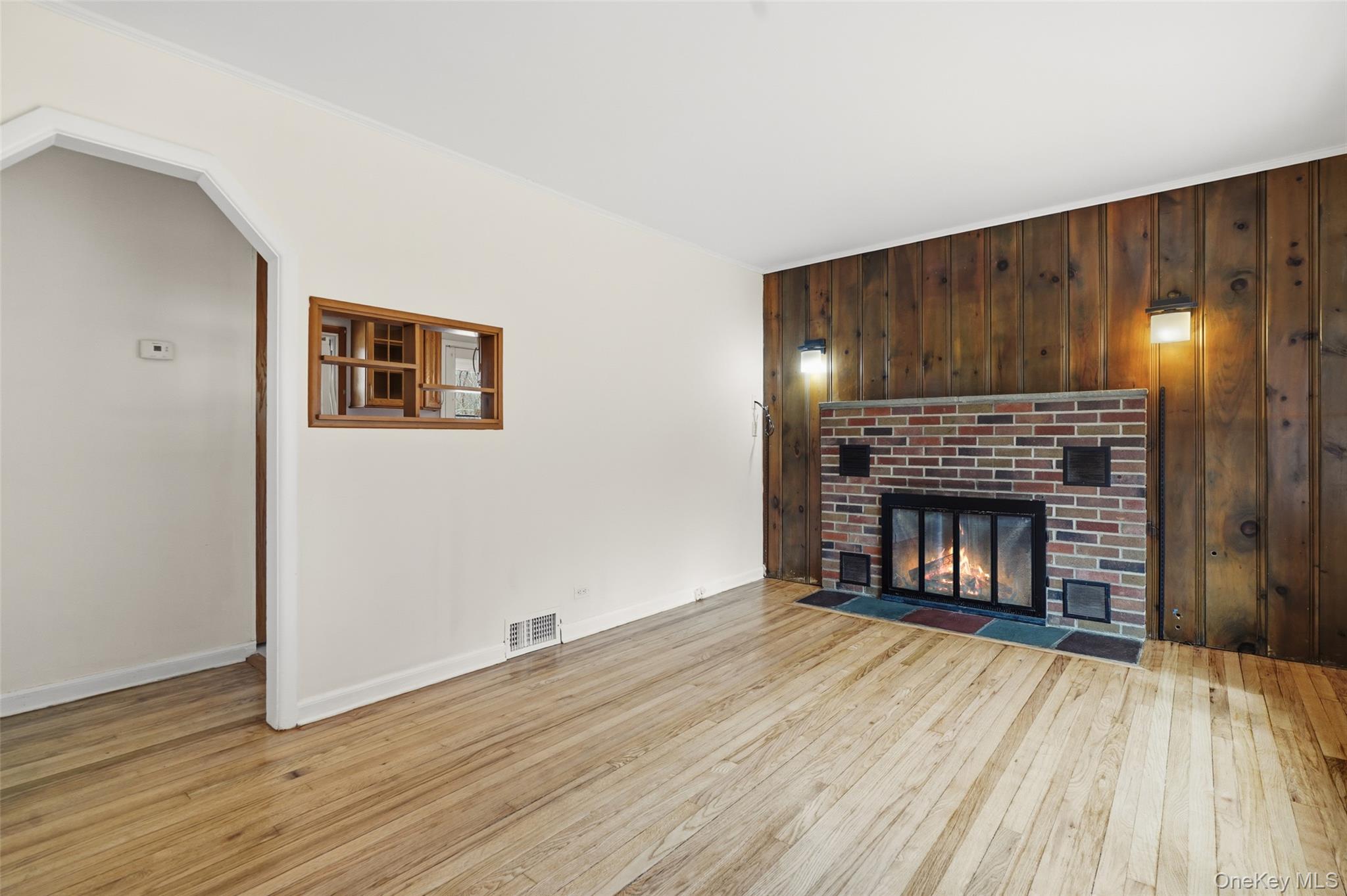 59 Brook Street Mahopac, NY 10541 - Photo 8 of 37 Living room with fireplace and arched doorway.