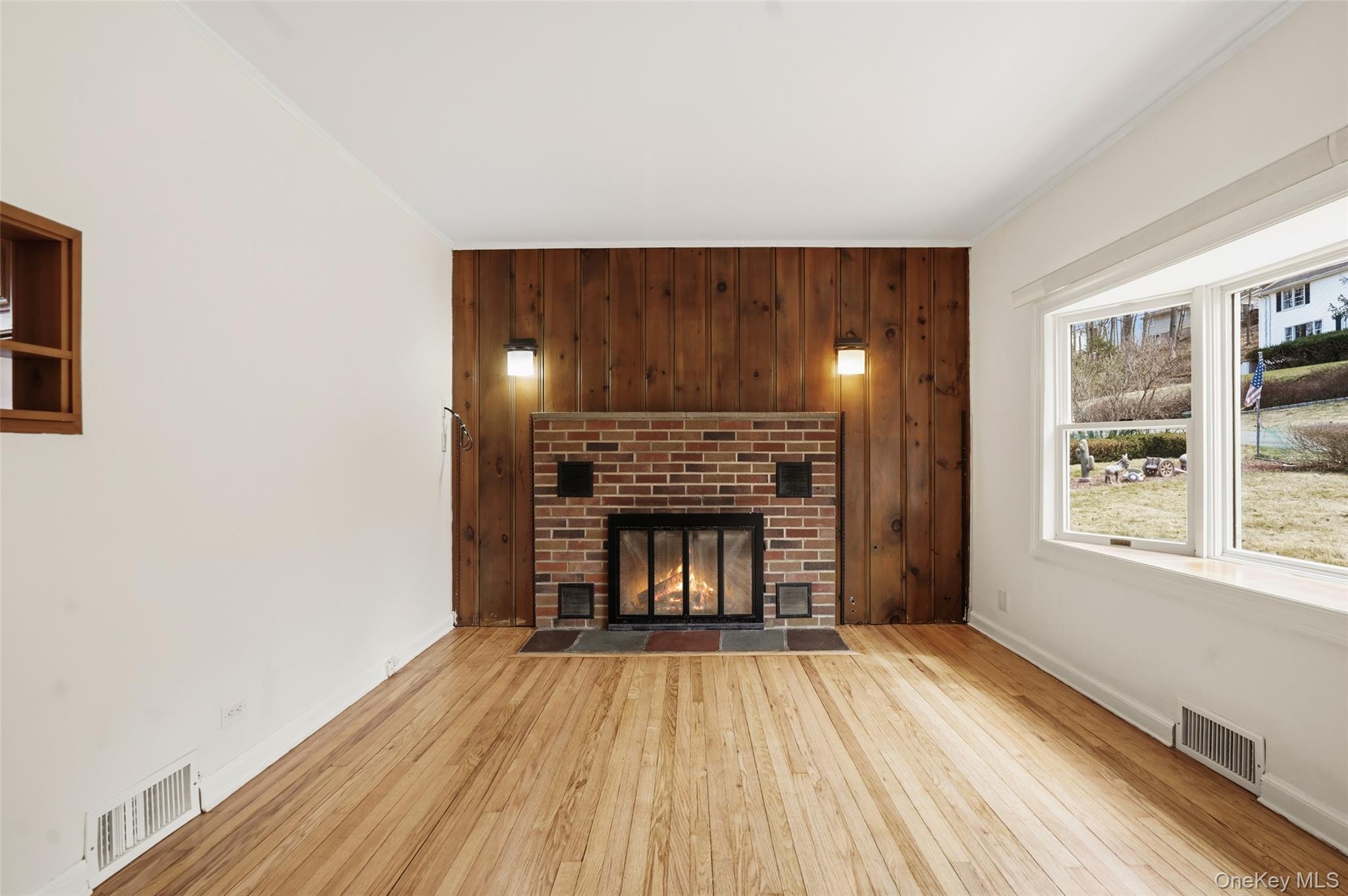 59 Brook Street Mahopac, NY 10541 - Photo 9 of 37 Cozy living room with fireplace and sconce lighting.
