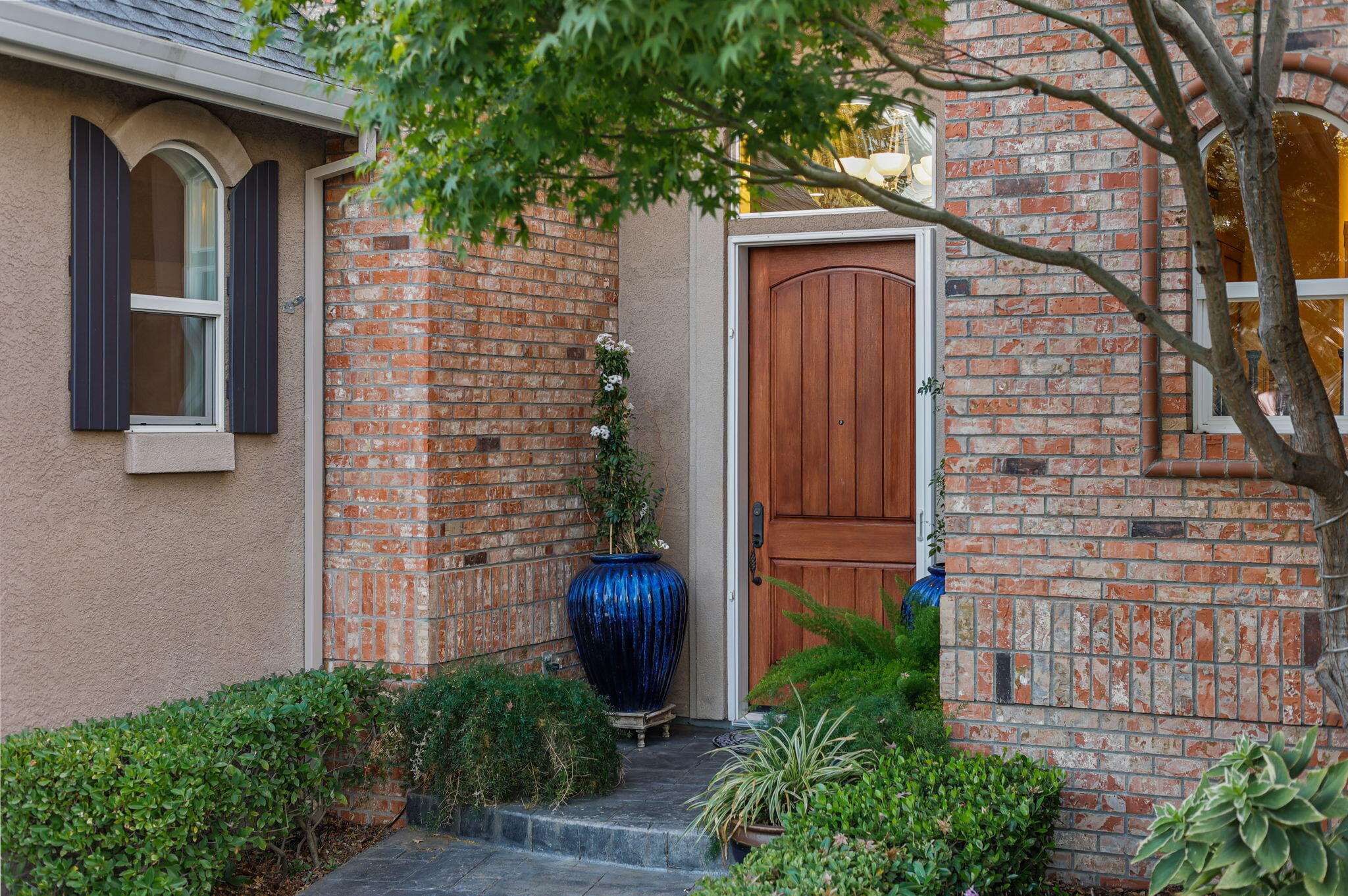 3582 Stone Ridge Place Redding, CA 96001 - Photo 3 of 34 a couple of potted plants in front of door