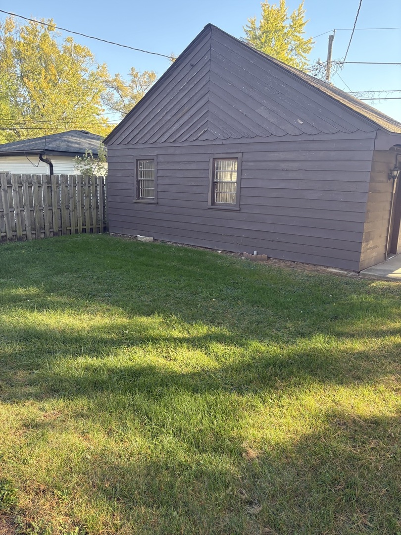 540 East 148th Place Harvey, IL 60426 - Photo 16 of 19 a view of a backyard with plants and large tree
