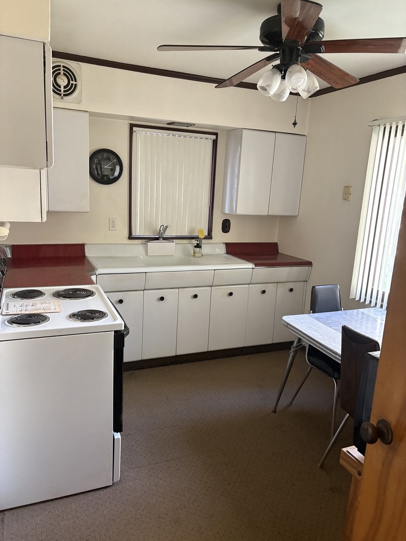 540 East 148th Place Harvey, IL 60426 - Photo 2 of 19 a kitchen that has a cabinets and a stove