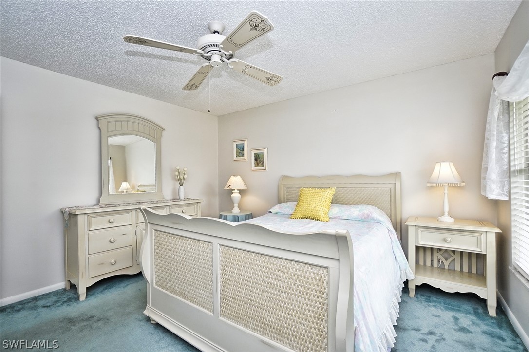 3011 Matecumbe Key Road, Unit 1 Punta Gorda, FL 33955 - Photo 11 of 14 a bedroom with a bed and a chandelier