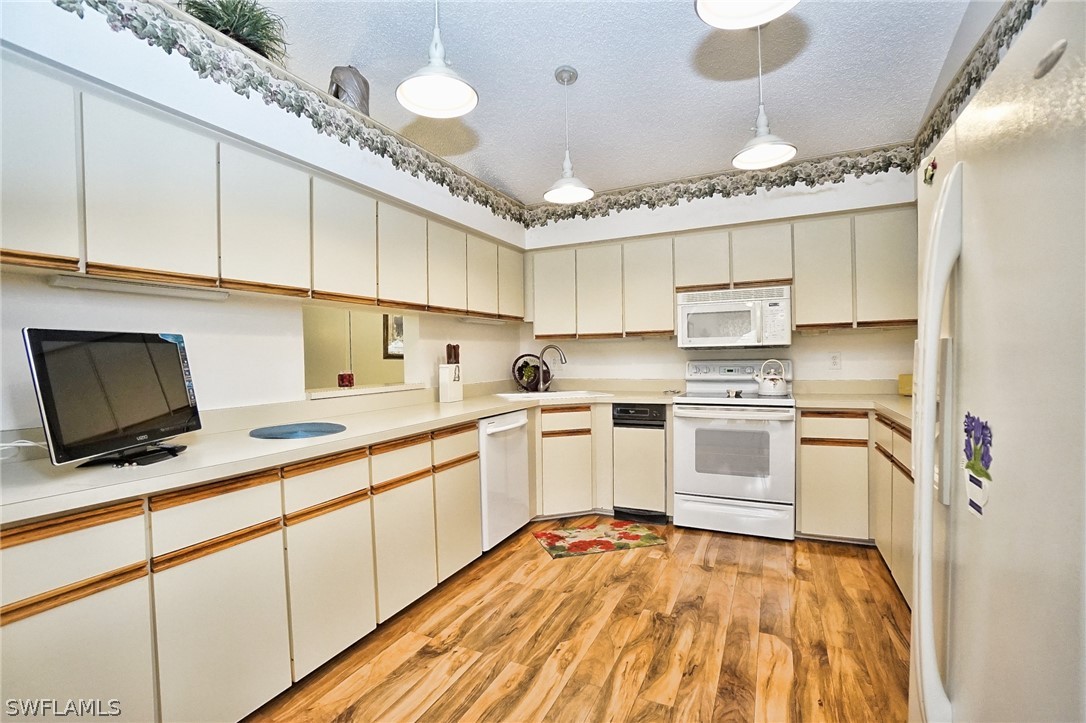 3011 Matecumbe Key Road, Unit 1 Punta Gorda, FL 33955 - Photo 6 of 14 a kitchen with granite countertop a sink stainless steel appliances and cabinets