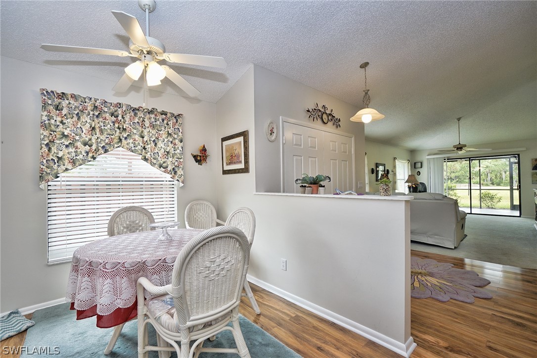 3011 Matecumbe Key Road, Unit 1 Punta Gorda, FL 33955 - Photo 9 of 14 a living room with furniture a chandelier and a fireplace
