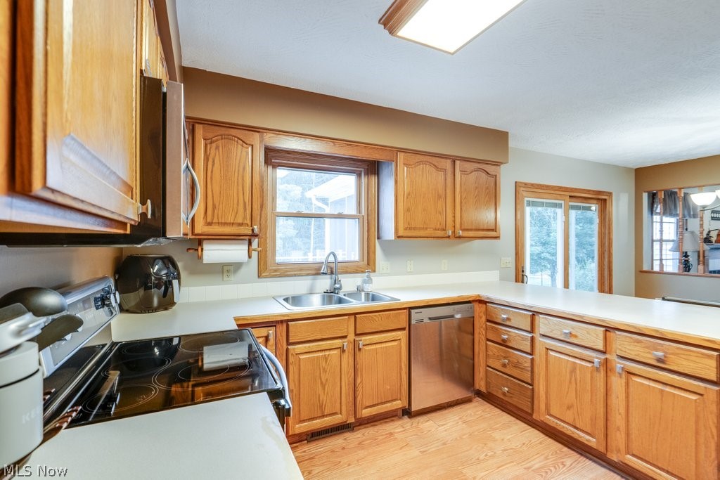 826 Stewart Road Kent, OH 44240 - Photo 25 of 43 Kitchen featuring electric range oven, light hardwood / wood-style flooring, sink, and stainless steel dishwasher
