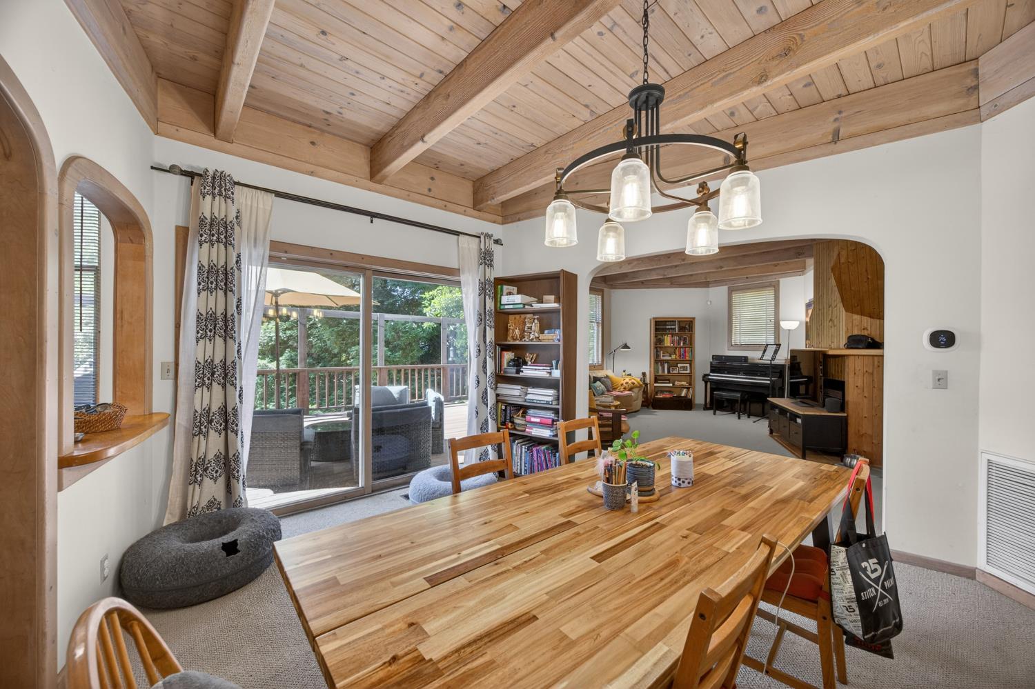 3940 Bannister Road Fair Oaks, CA 95628 - Photo 10 of 84 a dining room with wooden floor a chandelier a wooden table and chairs