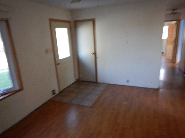 344 Hickory Avenue Romeoville, IL 60446 - Photo 5 of 11 an empty room with wooden floor and windows