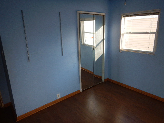 344 Hickory Avenue Romeoville, IL 60446 - Photo 7 of 11 an empty room with wooden floor and windows