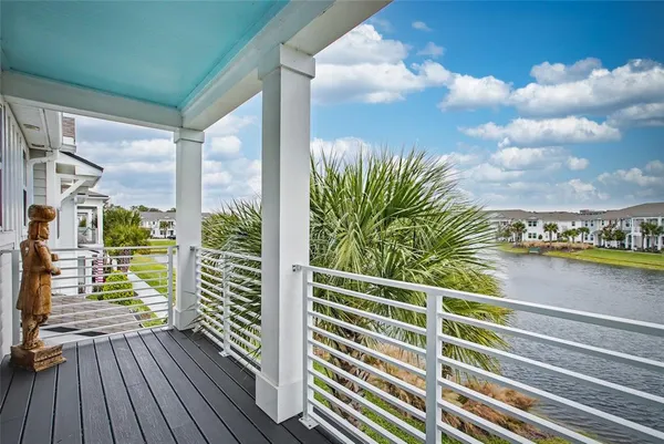 a view of a balcony with floor to ceiling windows wooden floor