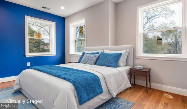 a bedroom with a bed and wooden floor