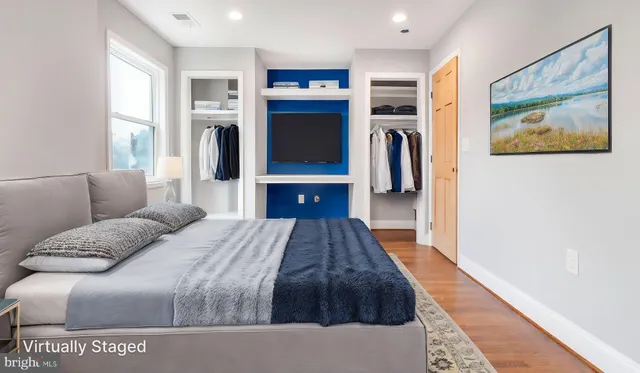 a bedroom with a large bed and a walk in closet