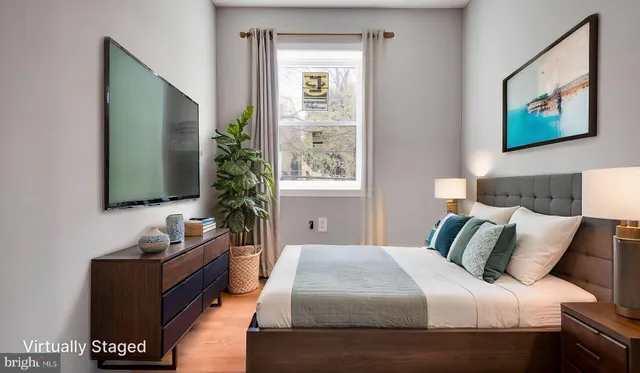 a bedroom with a large bed and a flat screen tv