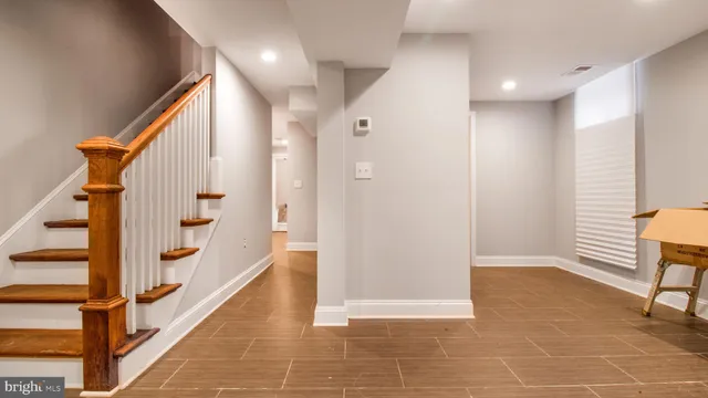 a view of an entryway with wooden floor and stairs
