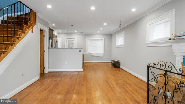 a view of a kitchen with wooden floor and electronic appliances