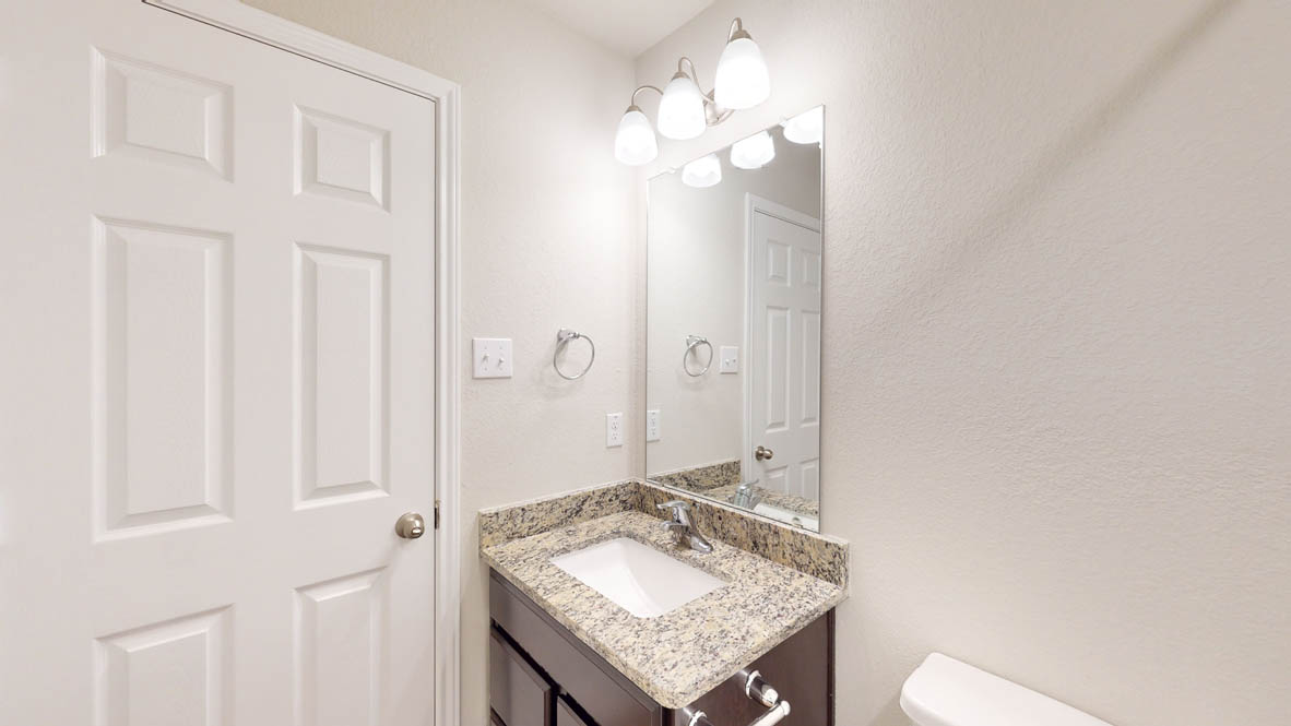 429 Creekfall Road Burnet, TX 78611 - Photo 25 of 28 Granite counters and a convenient vanity highlight this well-appointed bathroom.