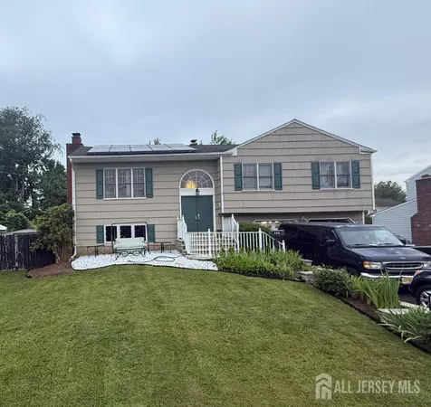 a view of a house with a yard and sitting area