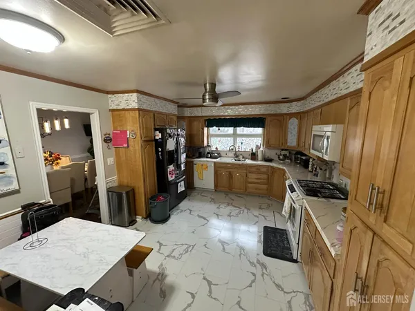 a kitchen with sink cabinets and stainless steel appliances