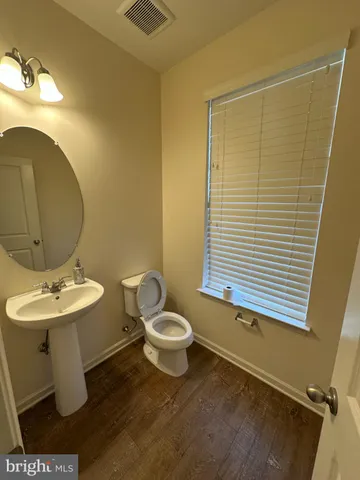 a bathroom with a sink a toilet and mirror