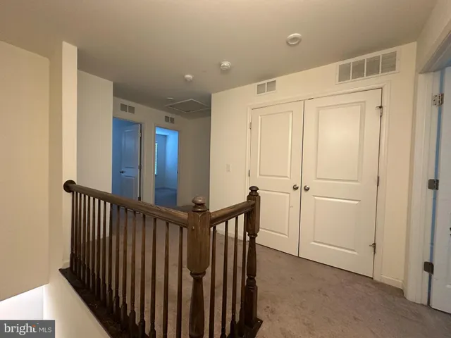 a view of a hallway with entryway door