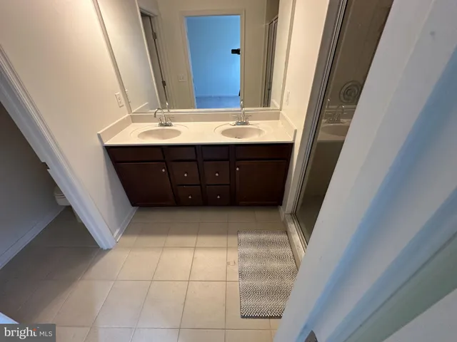 a bathroom with a sink vanity and mirror