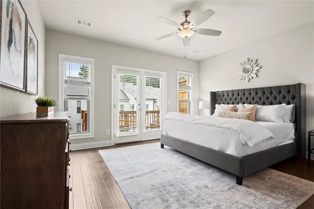 a bedroom with a large bed chandelier and a window