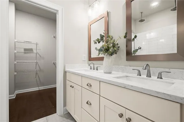 a bathroom with a double vanity sink and mirror