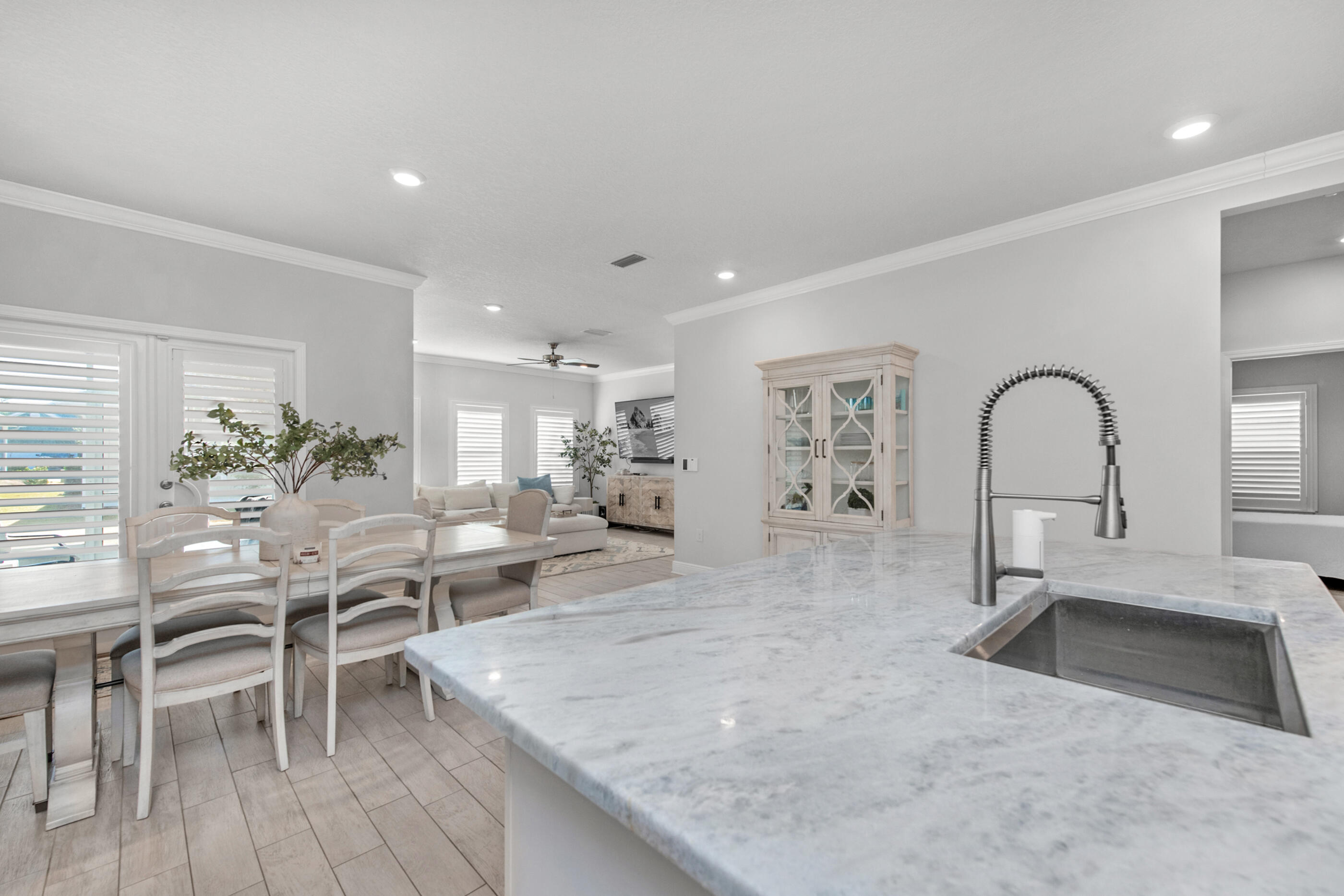 382 Lightning Bug Lane Freeport, FL 32439 - Photo 12 of 33 a living room with furniture a dining table with kitchen island stainless steel appliances sink and wooden floor