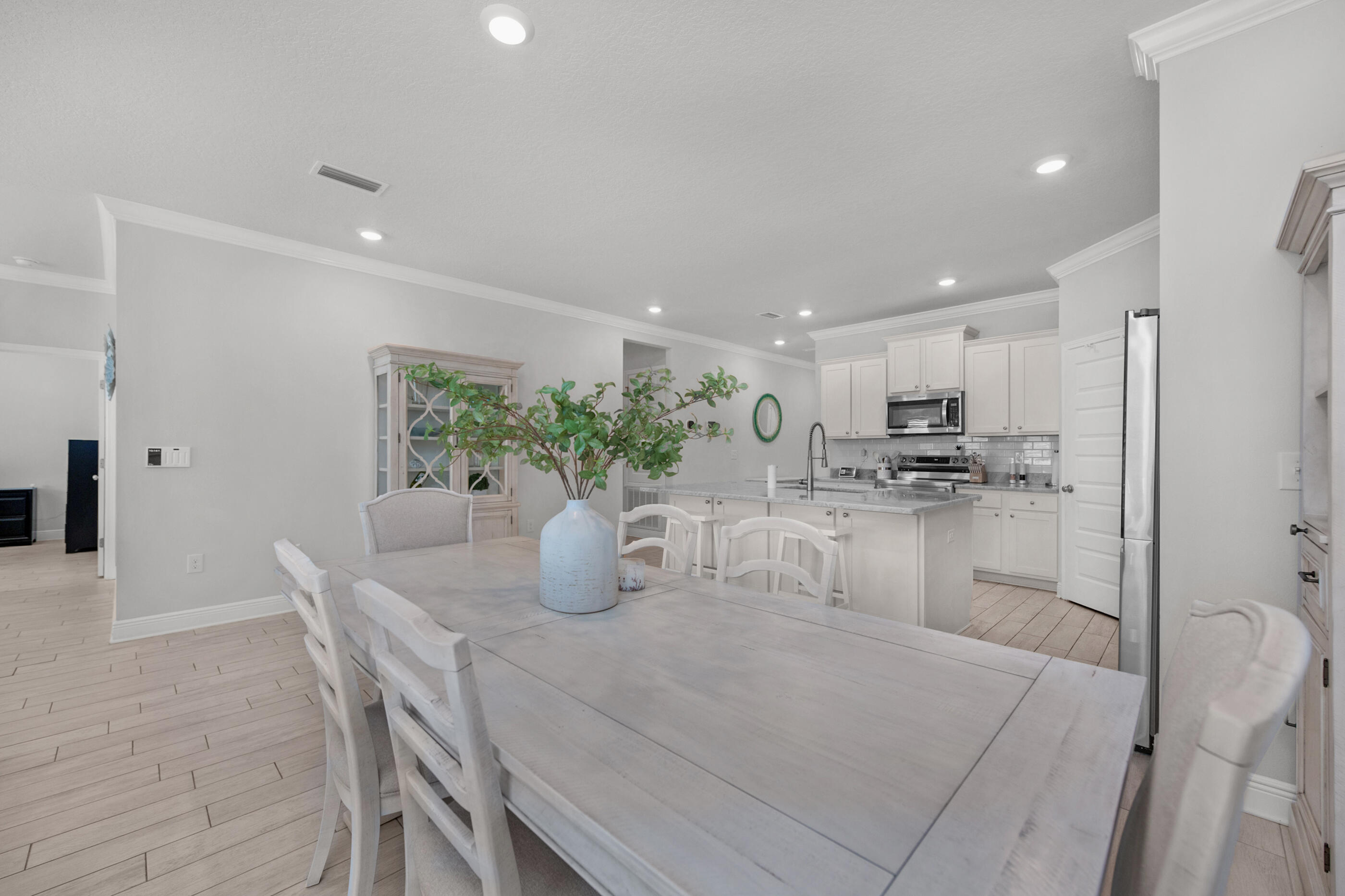 382 Lightning Bug Lane Freeport, FL 32439 - Photo 16 of 33 a dining room with kitchen island a table and chairs