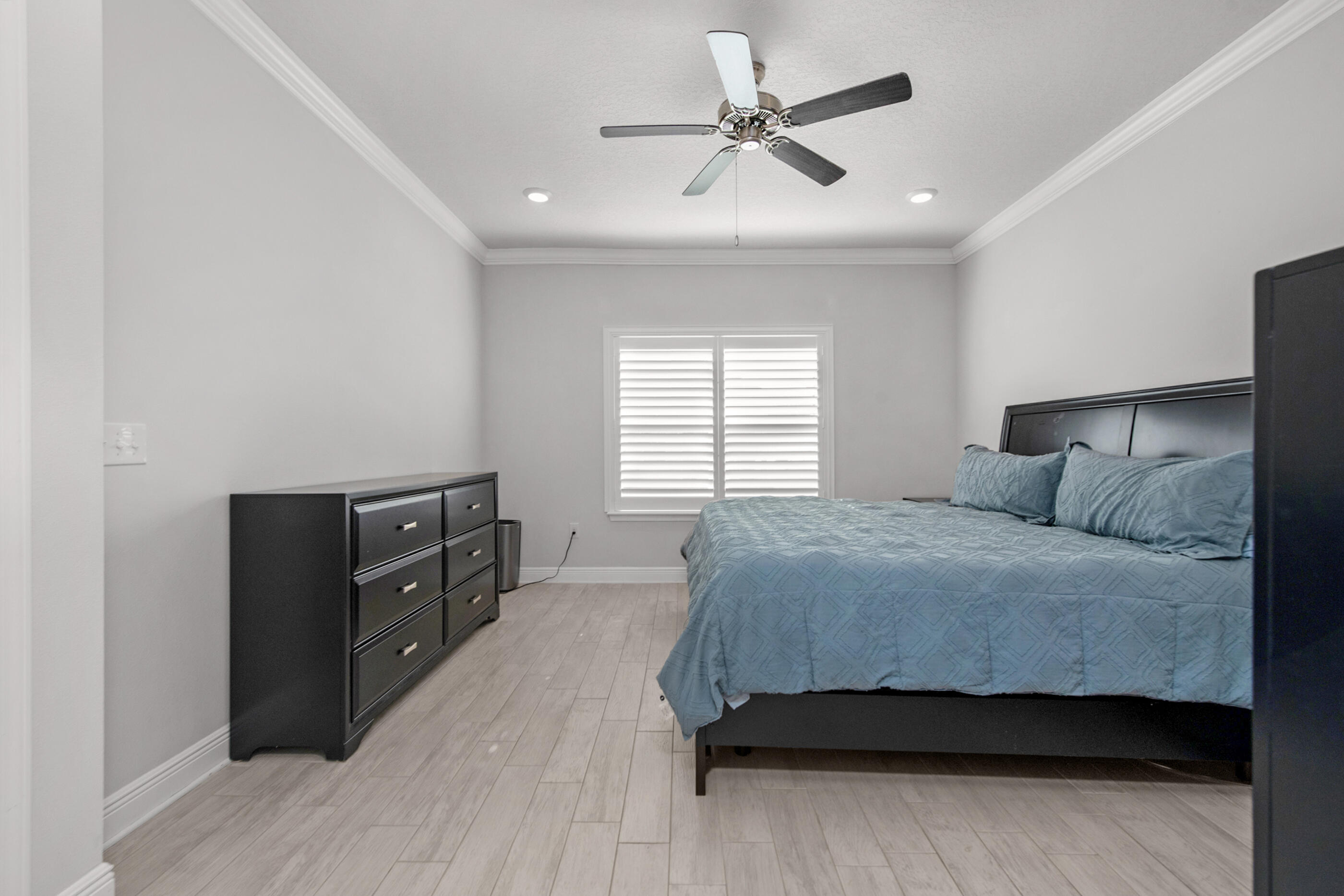 382 Lightning Bug Lane Freeport, FL 32439 - Photo 19 of 33 a bedroom with a bed and a ceiling fan