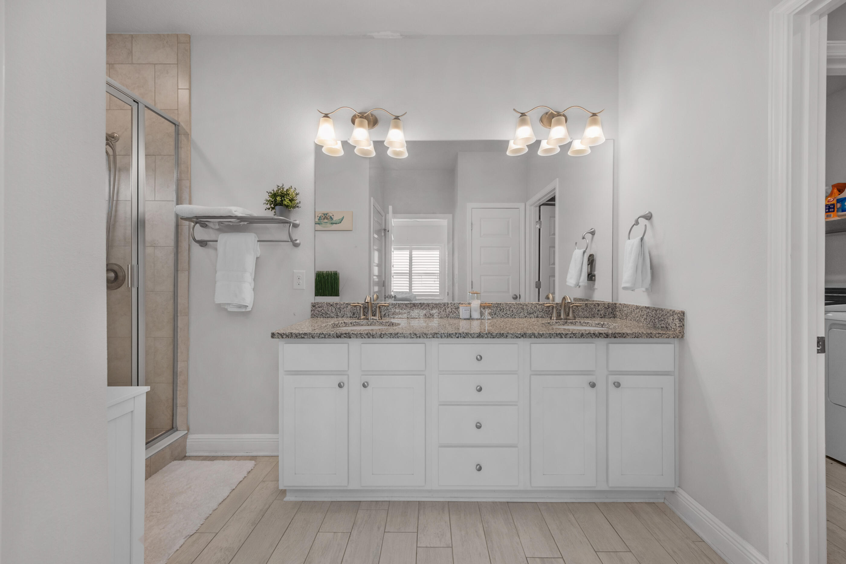 382 Lightning Bug Lane Freeport, FL 32439 - Photo 21 of 33 a bathroom with a granite countertop sink a mirror and a shower