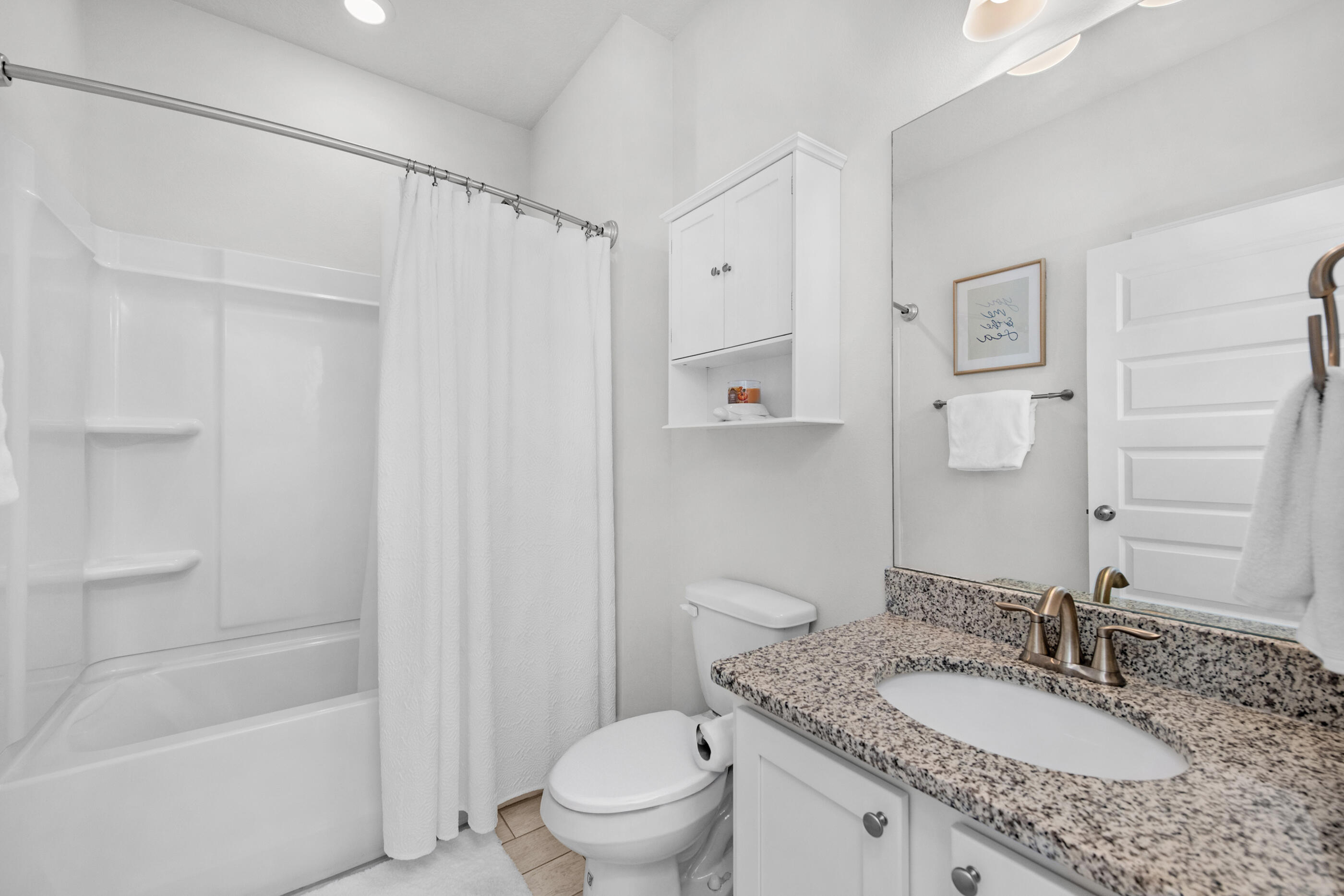 382 Lightning Bug Lane Freeport, FL 32439 - Photo 25 of 33 a bathroom with a granite countertop sink toilet and shower