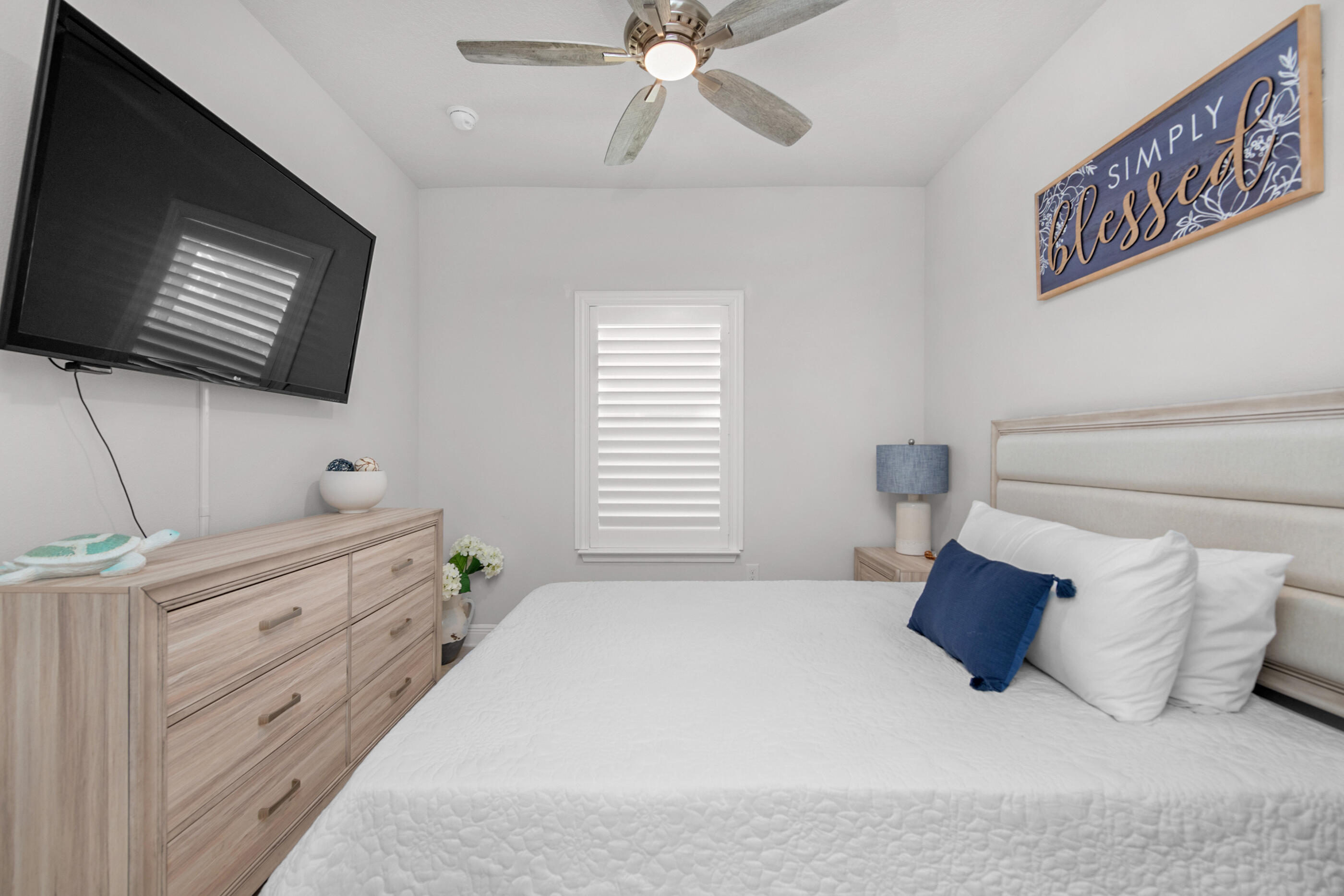 382 Lightning Bug Lane Freeport, FL 32439 - Photo 26 of 33 a bedroom with a bed and a flat screen tv