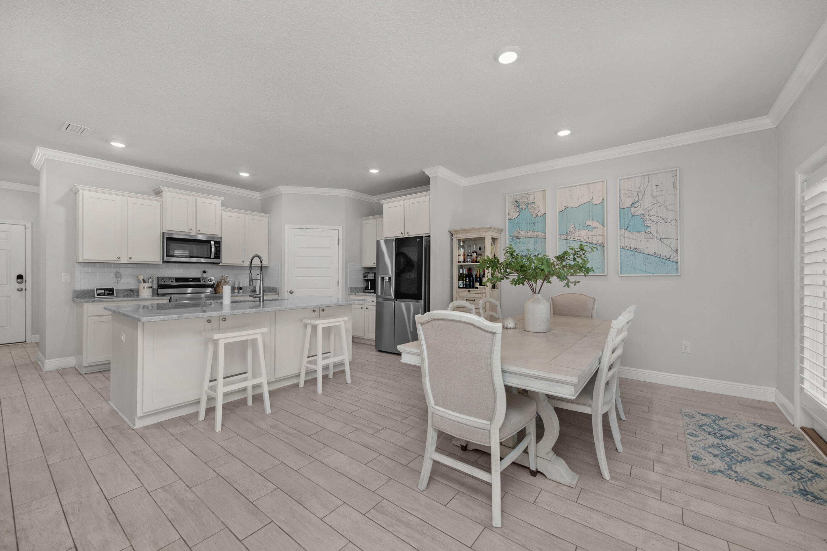 382 Lightning Bug Lane Freeport, FL 32439 - Photo 5 of 33 a kitchen with a dining table chairs stainless steel appliances and cabinets