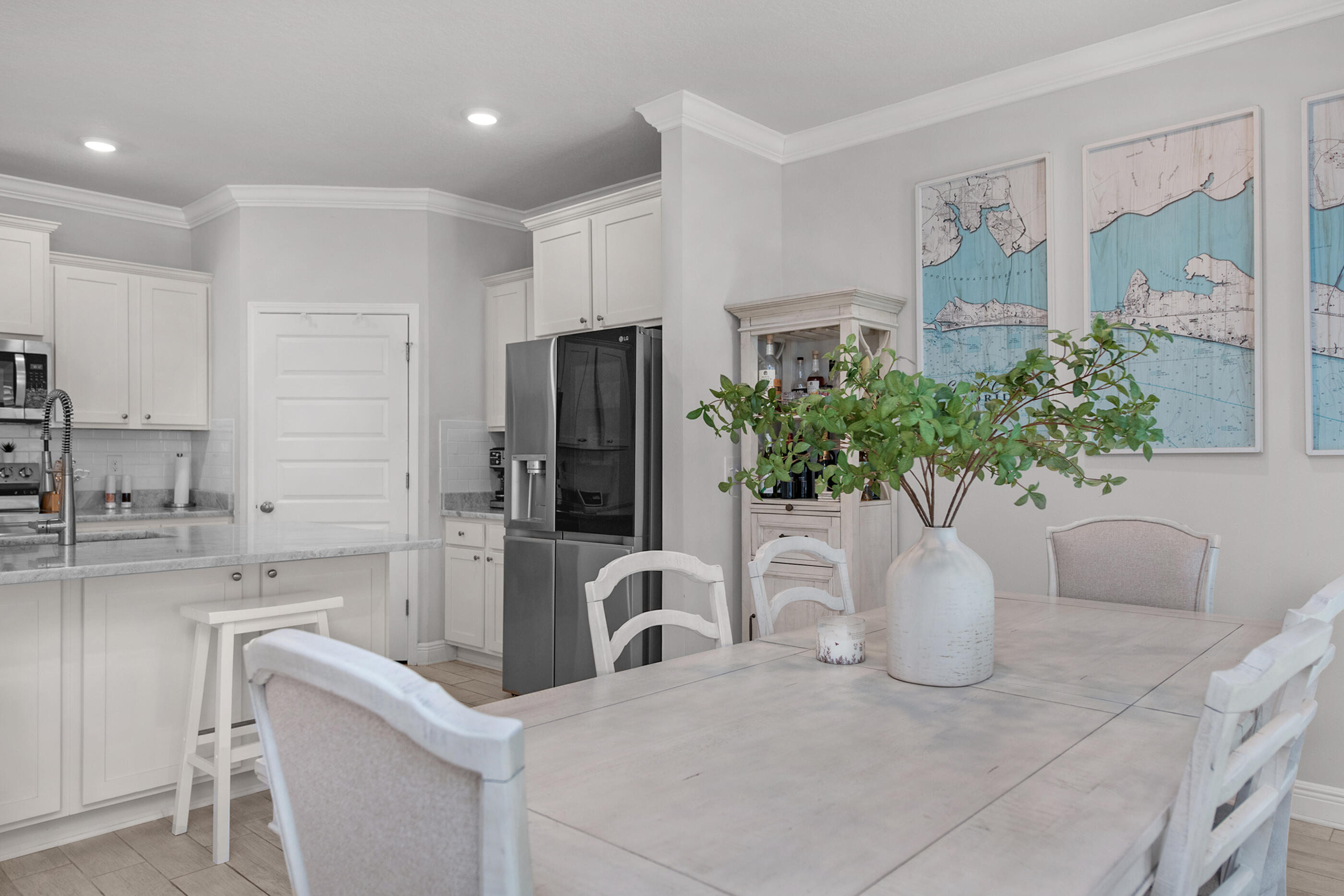 382 Lightning Bug Lane Freeport, FL 32439 - Photo 6 of 33 a white kitchen with stainless steel appliances a sink and a potted plant