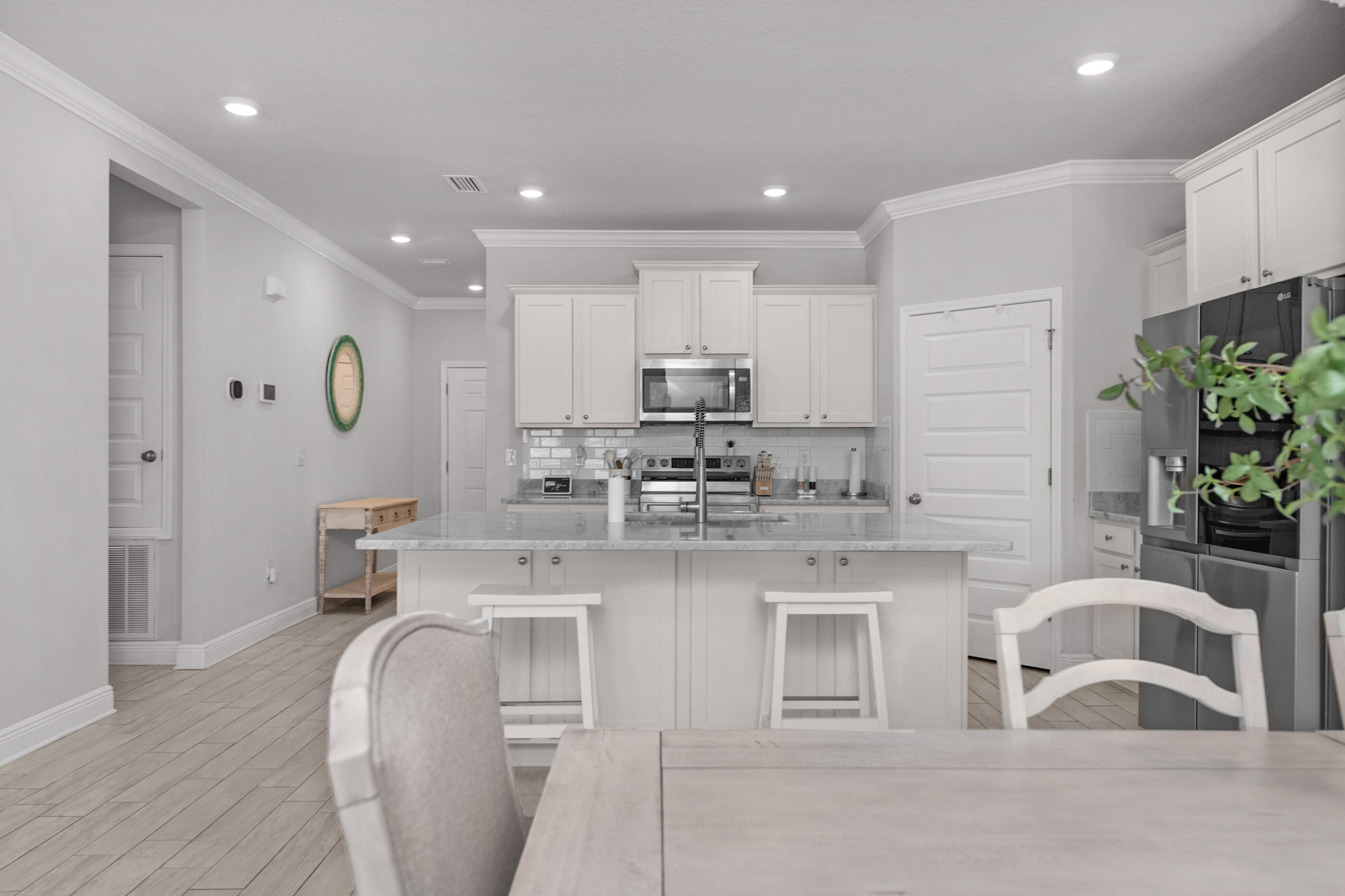 382 Lightning Bug Lane Freeport, FL 32439 - Photo 7 of 33 a kitchen with stainless steel appliances granite countertop a white cabinets and a granite counter tops