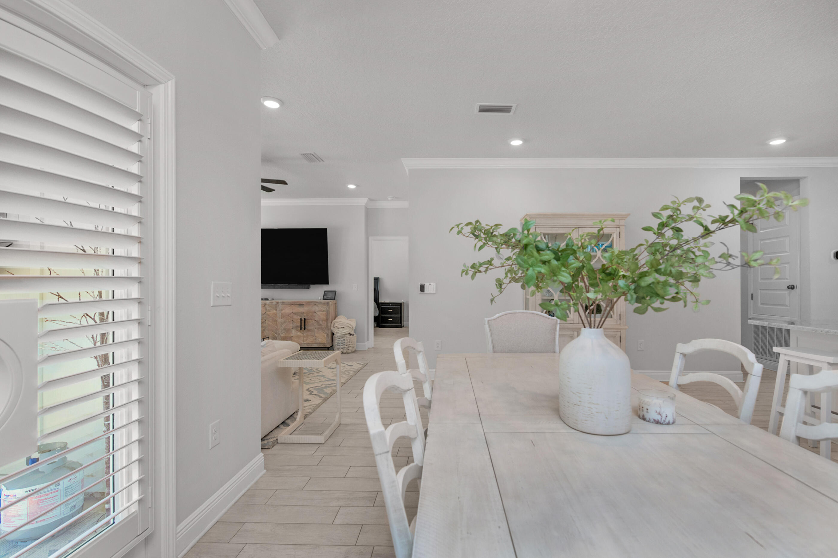 382 Lightning Bug Lane Freeport, FL 32439 - Photo 8 of 33 a white vase with flowers sitting on a table and chair