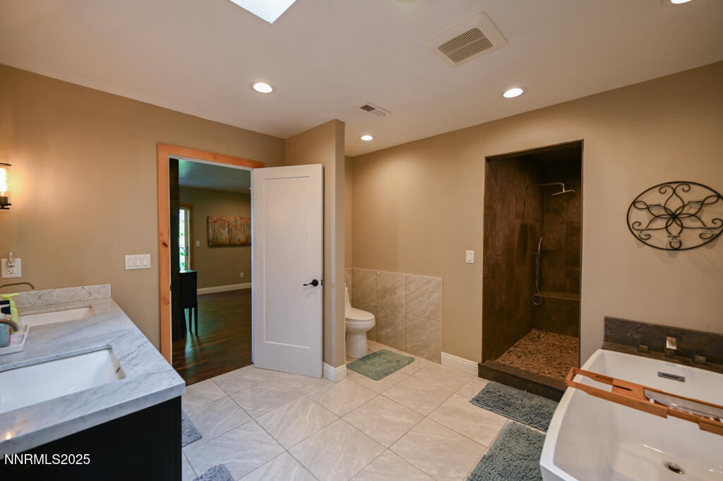 1147 Autumn Hills Road Gardnerville, NV 89460 - Photo 36 of 53 a bathroom with a sink a toilet and shower