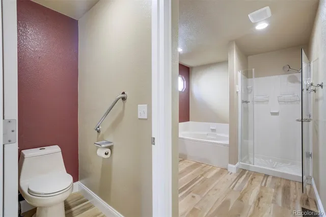a bathroom with a granite countertop toilet sink and shower